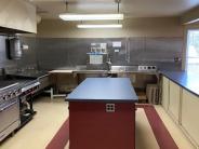 food prep island in first floor kitchen. blue and red colors